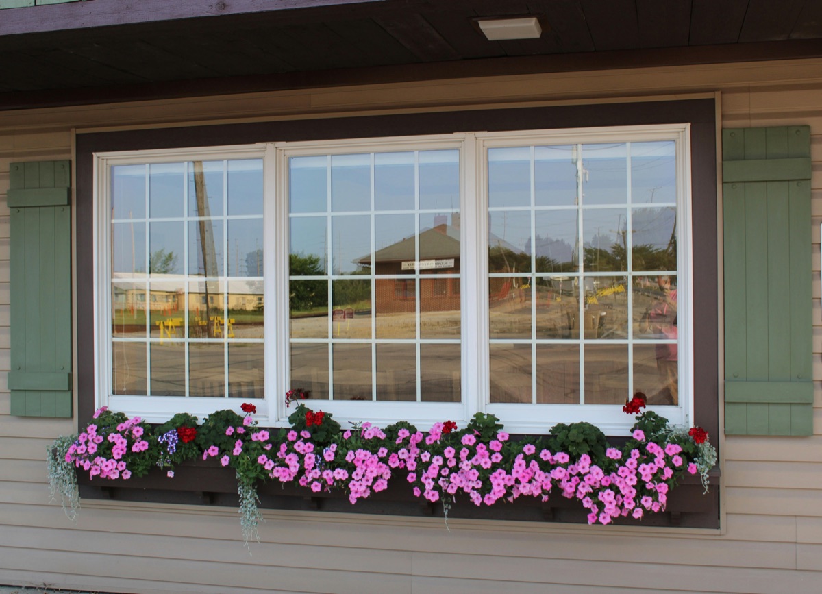 A new triple-pane vinyl window with white trim on a residential exterior — example of Storm Roofing window installation.